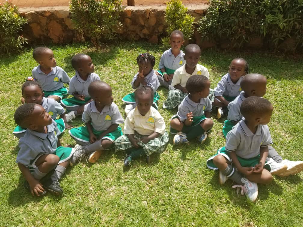 Children in a learning circle on the grass
